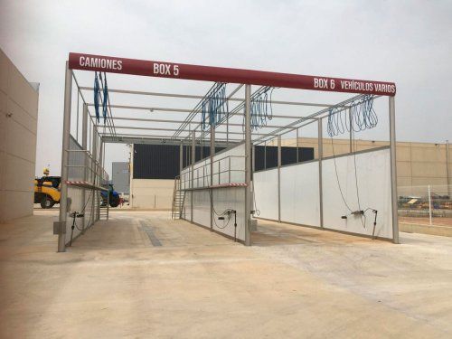 Estructura metálica para boxes de lavado instalada en una zona exterior con cerramientos laterales