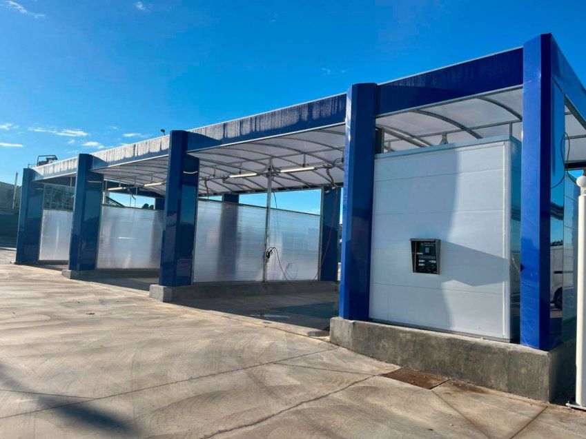 Estructura azul para boxes de lavado instalada en una zona exterior de un centro de lavado